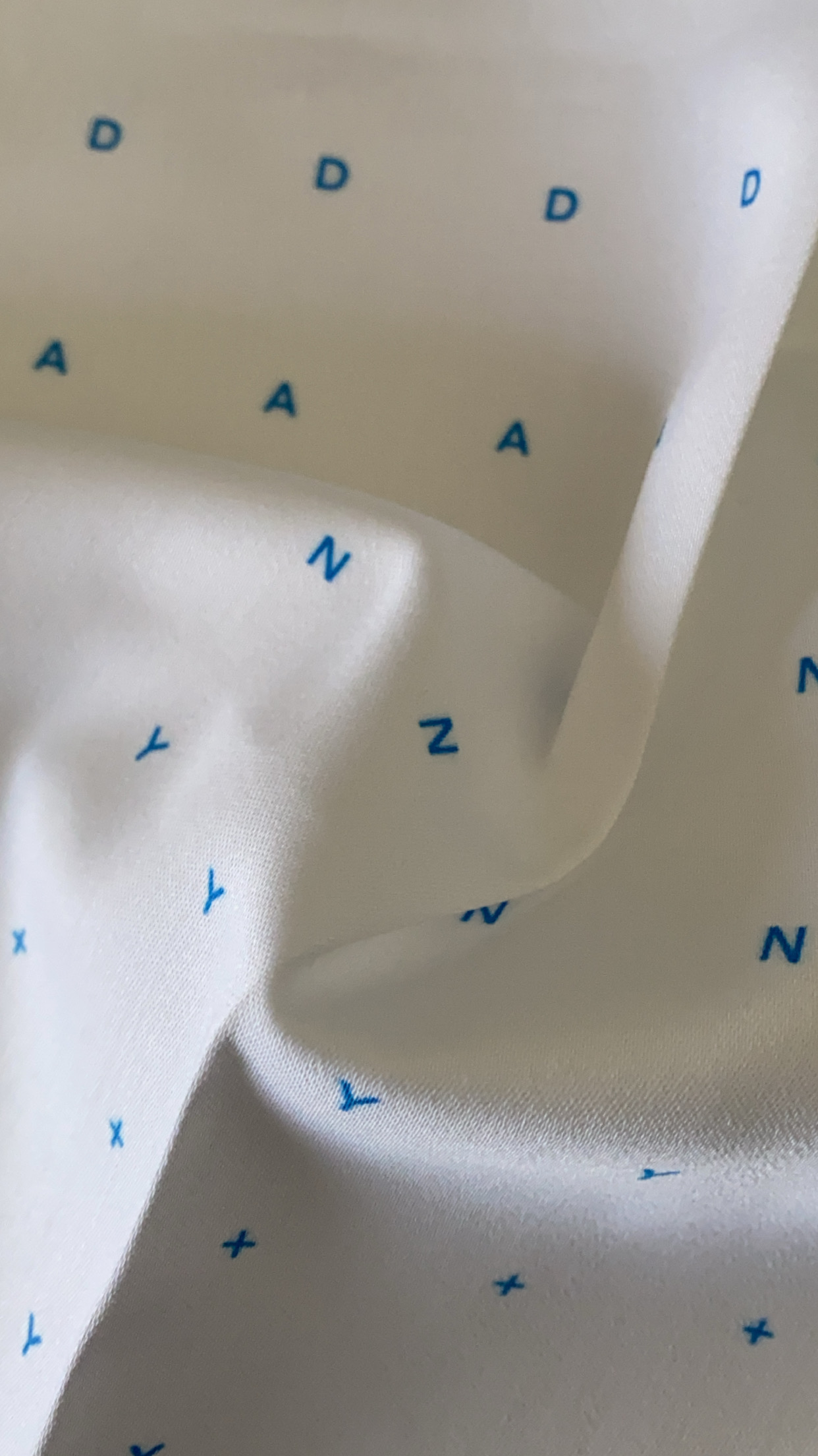 Custom branded print on fabric inspired by drafting paper.