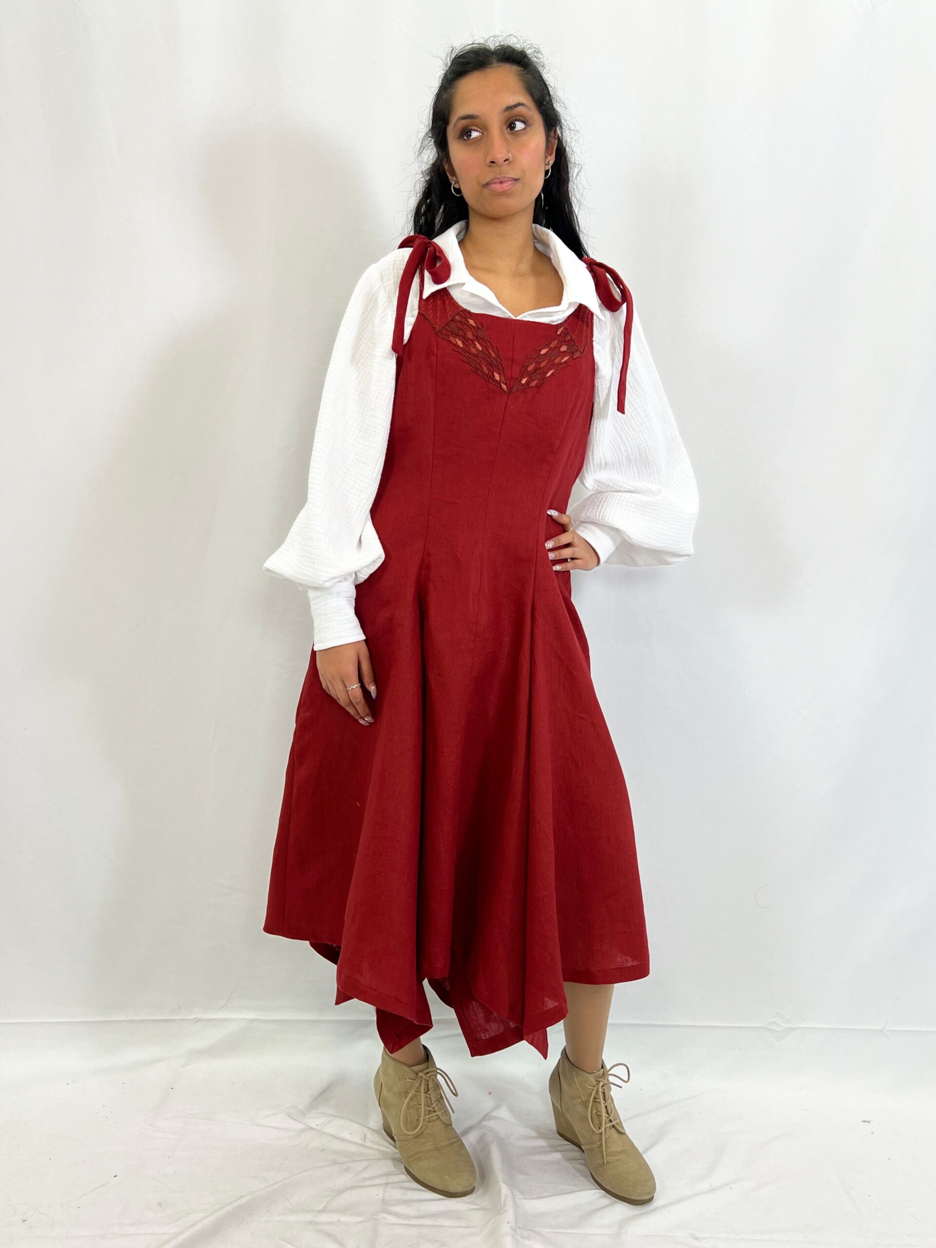 The Éléonore look features a cotton blouse with bishop sleeves and wide cuffs, and a linen dress with a handkerchief hem, princess seams, and hand-sewn embroidery at center front. Modelled by Alana Naraine.